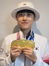 Archer An San celebrates her three gold medals won at the 2020 Tokyo Olympics. [YONHAP]