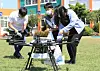 Students from Haeahn Elemenatry School on Jeju Island receive a box of sandwiches and snacks from convenience store GS25 delivered by a drone, on Monday. [YONHAP]