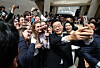 President Lee Jae Myung, front right, takes selfies with tourists visiting the National Museum of Korea in Yongsan District, central Seoul, on Feb. 26. Lee and first lady Kim Hea Kyung viewed a special exhibition on Admiral Yi Sun-shin and bought souvenirs at the museum. [JOINT PRESS CORPS]