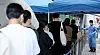 People line up to get tested for Covid-19 at a testing center in Yongsan District, central Seoul, on Thursday. [NEWS1]