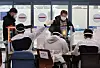 Visitors from Europe at Incheon International Airport are guided by quarantine officials on Thursday. Starting Friday, all foreigners who enter the country must submit a form proving they have tested negative for the coronavirus through a PCR exam. [YONHAP]