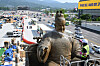A worker with a water jet cleans the statue of King Sejong the Great on Gwanghwamun Square in central Seoul on Monday. Behind the statue, construction of the extended square is seen. The construction is scheduled to be completed by Aug. 6.  [YONHAP]