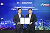 Choi Kang-rim, head of KT’s AI mobility business, and Eric Yeo, head of SingPost’s business technology solutions and property, pose for a photo after signing a memorandum of understanding at KT’s office in Songpa District, southern Seoul, on Thursday. [KT]