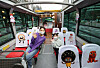 Models wave from inside a Seoul City Tour Bus parked at a bus station in Jung District, central Seoul, Thursday. The bus was decorated with characters from 'Bread Barbershop,' a Korean animated series, according to travel activities and services booking platform Klook on Thursday. The Bread Barbershop-themed city tour bus will start operation in April. [YONHAP]