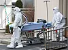 Medical workers in protective gear transfer a Covid-19 patient at Seoul Medical Center in Jungnang District, eastern Seoul, on Tuesday. [YONHAP]