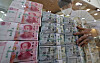 Yuan, dollar and yen bills are stacked in the counterfeit response unit at Hana Bank's main branch in Jung District, central Seoul, in October last year. [YONHAP]