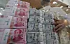Yuan, dollar and yen bills are stacked in the counterfeit response unit at Hana Bank's main branch in Jung District, central Seoul, in October last year. [YONHAP]