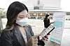 A visitor to Seoul Arts Center uses KT's Call Check-in service via her smartphone in Seocho District, southern Seoul, on June 7. [YONHAP]
