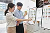 Models use a digital kiosk developed by Samsung Electronics to order drinks at the C+Urban Smart Cafe located in Gangnam, southern Seoul. Samsung Electronics announced Monday it would be supplying its self-ordering kiosk systems to coffee chain C+Urban. [YONHAP]