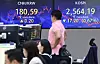 Screens in Hana Bank's trading room in central Seoul show foreign and stock markets close on Wednesday. [YONHAP]
