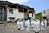 A team of firefighters and forensic workers conduct a joint investigation on Tuesday at a lithium battery plant in Hwaseong, Gyeonggi, where a fire broke out on Monday, resulting in 23 deaths. [YONHAP]