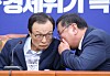 Democratic Party Chairman Lee Hae-chan, left, listens to Rep. Kim Tae-nyeon, floor leader, during the Supreme Council meeting on Monday.  [YONHAP]