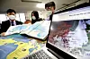 Members of the Voluntary Agency Network of Korea review maps of the East Sea in their office in Seongbuk District, northern Seoul, Tuesday as the International Hydrographic Organization (IHO) reached a consensus Monday to name global seas with numerical codes rather than specific names. Korea and Japan have struggled over the name the body of water between the two countries as Tokyo has called for the sole use of the Sea of Japan moniker. [YONHAP]