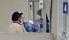 A man gets tested for Covid-19 at a testing center in Songpa District, southern Seoul, on Thursday. [YONHAP]