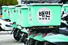Motorcycles of Baedal Minjok delivery workers are parked in Seoul. [YONHAP]