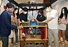 Czech Ambassador to Korea Gustav Slamecka, center, professor Kim In-chon of Czech and Slovak studies at Hankuk University of Foreign Studies, far left, and students majoring in Czech studies at the university try their hand at puppetry at the ″Secrets of Wooden Puppets: Czech Marionettes″ exhibition at the Seoul Museum of History in central Seoul on Thursday. [PARK SANG-MOON]