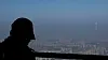 A person looks down into a hazy Seoul from the west gate of Namhansanseong Fortress on March 11. [YONHAP]