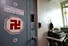 A symbol commonly associated with Buddhist temples and fortune tellers can be seen affixed to the front door of former Defense Intelligence Command chief Noh Sang-won's residence in Ansan, Gyeonggi, on Friday. A pile of dried fish, commonly used in shamanistic rituals, is on the right. [NEWS1]