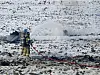 Firefighters pour water onto the site of a warplane crash in Hoengseong County, about 140 kilometers (87 miles) east of Seoul, on Dec. 26. [YONHAP]