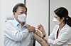 President Moon Jae-in, left, receives a Covid-19 vaccine booster shot Friday at the National Medical Center in central Seoul ahead of an overseas trip at the end of this month. [YONHAP]