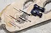 Park Jong-gun's jangdo with Lim Keum-hee's dahoe straps attached to each one, along with blue shoes that were worn to match the ceremonial robes of queens, also made by Lim [KOREA CRAFT & DESIGN FOUNDATION]