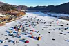 As a bitter cold spell continues, tents used by winter campers dot the frozen surface of the Bukhan River near Jichon-ri, Sabuk-myeon, Chuncheon, Gangwon, on Jan. 25. [YONHAP]