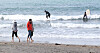 People walk along the coast in bare feet at Iho Tewoo Beach, Jeju, on Sunday. [NEWS1]
