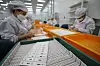 Covid-19 rapid antigen kits are produced at RapiGen in Suwon on Monday. [NEWS1]
