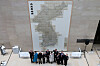 National Museum of Korea Director You Hong-june, fifth from left, poses for a photo in front of the newly installed life-size copy of the Daedongyeojido at the Path to History hallway on the first floor of the museum on Feb. 12. The Daedongyeojido, also known as the Map of the Great East, is Korea's first large-scale map created by cartographer Kim Jeong-ho in the 19th century and is listed as Korea's National Treasure No. 850. Measuring 6.7 meters (nearly 22 feet) in length and 3.8 meters in width, the map divides the Korean Peninsula into 22 sections, each compiled into a separate booklet, making it difficult to display in its entirety. [YONHAP]