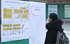A test-taker and aspiring teacher looks at the seat map attached to the board for the second round of the city’s elementary teacher employment examination at Seoul Technical High School in Seoul on Jan. 13, 2021. [NEWS1]