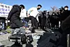 In front of the National Assembly on Wednesday, owners of coin noraebang, or booth-type singing rooms, stage a press event at which they destroy singing room equipment to protest the government’s social distancing measures. They pledged they will not obey any shutdown order after Jan. 18. [NEWS1]