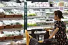 A woman browses packaged vegetables at a hypermarket in Seoul on Sunday. [YONHAP]