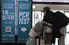 An arrival from abroad passes by banners that lead to Covid-19 testing centers at Gimpo International Airport on Dec. 29. [NEWS1]