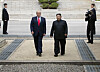 U.S. President Donald Trump, left in center, and North Korean leader Kim Jong-un walk on the North Korean side of the demilitarized zone in their third ― and impromptu ― meeting at the truce village of Panmunjom in June last year. [YONHAP]