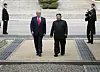 U.S. President Donald Trump, left in center, and North Korean leader Kim Jong-un walk on the North Korean side of the demilitarized zone in their third ― and impromptu ― meeting at the truce village of Panmunjom in June last year. [YONHAP]