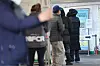 People wait in line to get tested for Covid-19 at a testing center in Yongsan, central Seoul, on Monday. [YONHAP]
