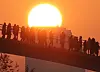 People watch the first sunrise of the New Year from the bridge leading to Seonyu Island in western Seoul Sunday, heralding in the Year of the Rabbit. [NEWS1]