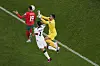 Morocco's Youssef En-Nesyri, left, heads the ball to score the opening goal past Portugal's goalkeeper Diogo Costa, right, during the World Cup quarterfinal match between Morocco and Portugal, at Al Thumama Stadium in Doha, Qatar on Saturday. [AP/YONHAP]
