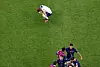England's Harry Kane reacts after the match on Saturday when England were eliminated from the World Cup while France's Raphael Varane celebrates with teammates as France progressed to the semi finals. [REUTERS/YONHAP]