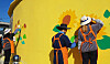 Volunteers paint the wall of a village in South Jeolla in November 2019. The government's third supplementary budget includes painting projects that will give temporary jobs to 8,500 artists. [South Jeolla Government