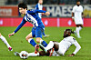 K.A.A. Gent's Hong Hyun-seok, left, fights for the ball with Genk's Tolu Arokodare during a Belgian Pro League match in Ghent on Sunday.  [AFP/YONHAP]
