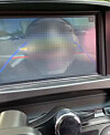 A face seen through a vehicle's rear-view camera. [SCREEN CAPTURE]