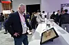 A visitor to the SK On booth at CES 2023 browses a news article by the Korea JoongAng Daily featured alongside a battery on Jan. 5 in Las Vegas. [SK ON]