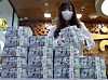 A banker checks dollars at KEB Hana Bank's Counterfeit Notes Response Center in Seoul on July 3, 2024. [YONHAP]