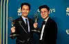 Actor Lee Jung-jae, left, and direcor Hwang Dong-hyuk, right, hold up their Emmys during the 74th Primetime Emmys at Microsoft Theater on September 12, 2022 in Los Angeles, California. [AFP]