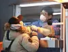 A frontline medical worker administers a coronavirus test at a Covid-19 testing site in Jung District, central Seoul, Saturday. [YONHAP]