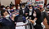 Opposition People Power Party lawmakers attempt to block the approval of an amendment to the Press Arbitration Act by Culture Committee Chairman Do Jong-hwan on Thursday. [YONHAP]