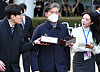 Former Justice Minister Cho Kuk, center, speaks to the press on Friday outside the Seoul Central District Court in Seocho District, southern Seoul, after the court sentenced him to two years in prison. [YONHAP]