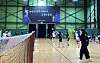 Members take turns practicing badminton at a gym. [ECOCK]
