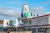 Boogi the seagull, Busan Expo 2030 mascot, sits on a Seine River cruise boat in Paris on Tuesday as the Bureau International des Expositions (BIE) holds its General Assembly in Paris from Nov. 28 to 29. The eight-meter (26-feet)-tall mascot wears glasses, has 'EXPO' glasses on its head and holds a macaroon to promote its bid to host the World Expo. [YONHAP]